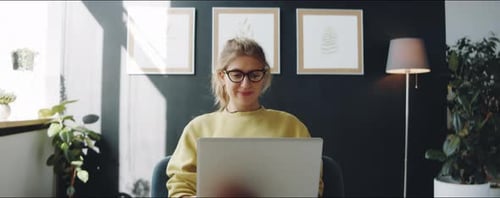 Young Woman on Laptop Video Call at Home