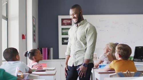 Bearded Teacher Interacting With Children in Classroom