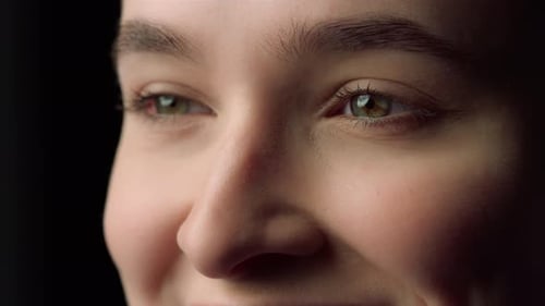 Young Woman's Face Close-Up in Dramatic Lighting