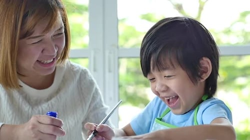 Woman and Child Painting Together at Home