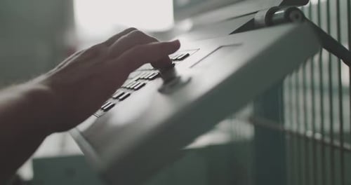 Close Male Hand Pushes the Control Desk Buttons During a Factory Workflow