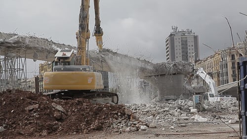 Excavator Demolishes Concrete Overpass in Urban Area