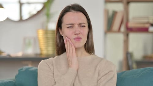 Portrait of Sick Young Woman Having Toothache at Home
