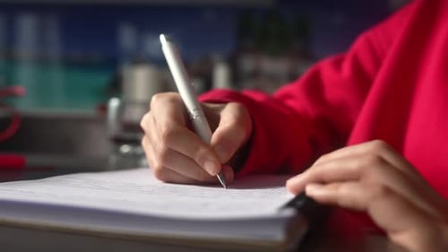 Young Woman Making Notes Close Up View