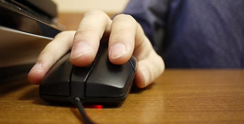 Hand Using Computer Mouse on Desk Close Up