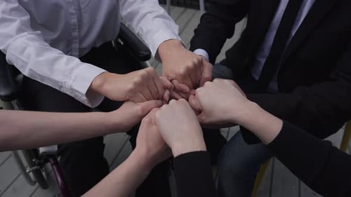 Hands of Unrecognizable Business Team Putting Fists Together