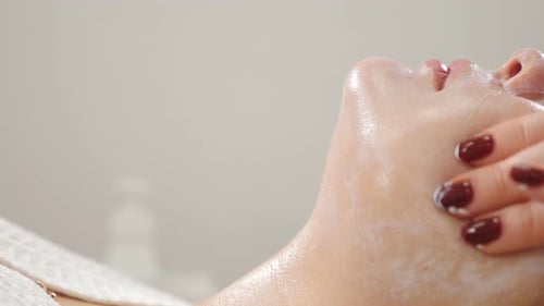 Wellness and Beauty Salon. Relaxing and Health. Spa Woman Facial Massage. Female Enjoying Relaxing