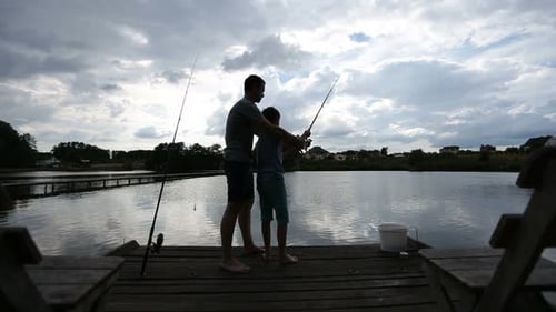 Teenage Boy Learning To Fish with Fishing Rod