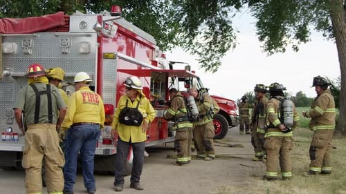 Firefighters Standing near Fire Truck in Rural Setting