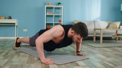 Young Man Is Doing Push-Ups at Home