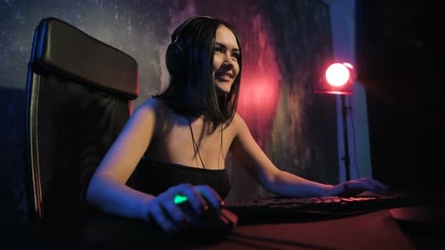Young Woman Plays Video Game with Headset in Dark Room