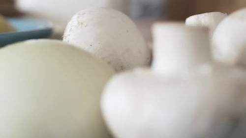 White Mushrooms and Onion on Blue Plate