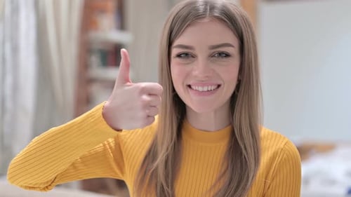 Smiling Woman Giving Thumbs Up Gesture Indoors