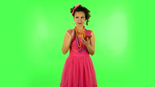 Young Smiling Woman Texting on Her Phone on Green Screen
