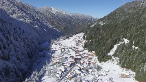 Aerial View of a Snowy Village in Mountains