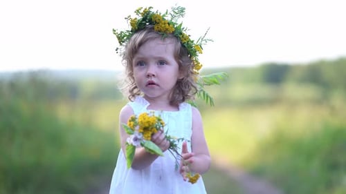 Child in White Dress with Flowers in Rural Area
