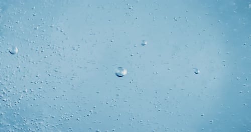 Bubbles Rising in Clear Blue Liquid