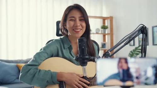 Cheerful Woman Singing and Playing Acoustic Guitar