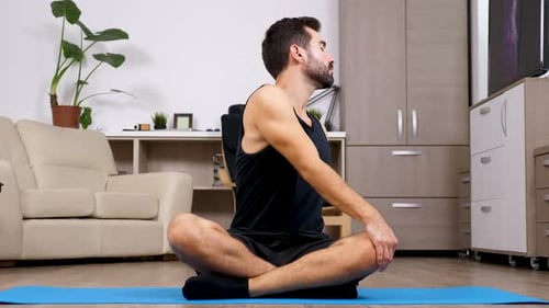 Man Meditating at Home on Yoga Mat