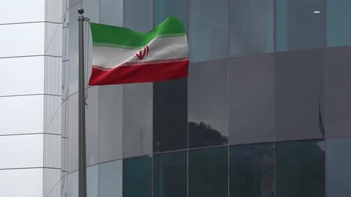 Flag of Iran Waving on Corporate Office Building