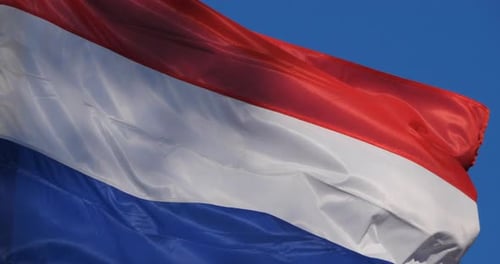 The national dutch flag waving in the wind.