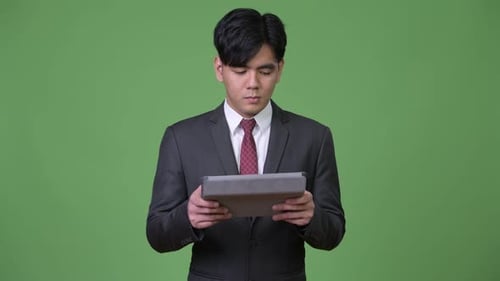 Young Adult Using Tablet in Business Suit
