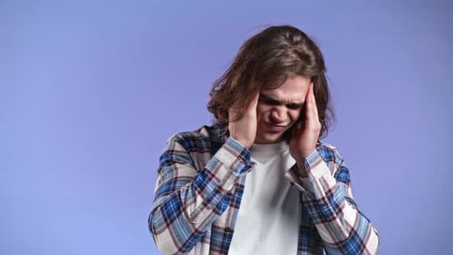 Young Man Having Headache Studio Portrait