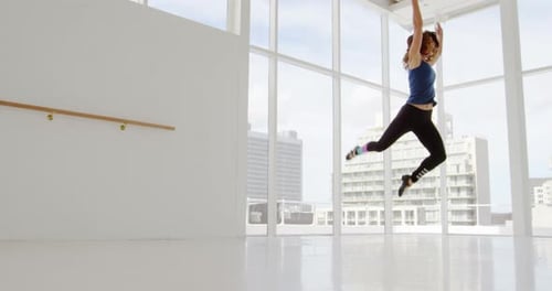 Graceful Woman Practicing Ballet in Bright Studio