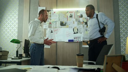 Two Men Discussing Investigation in Office