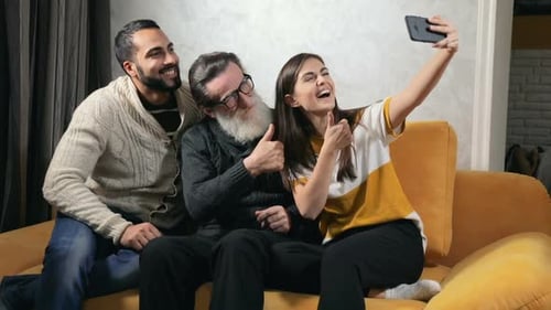Three Family Members Take a Fun Selfie on Couch