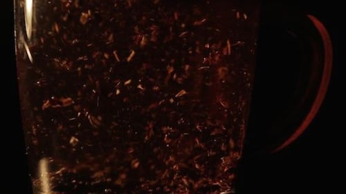 Water Poured Into Tea Leaves in Clear Mug