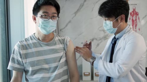 Doctor Giving Patient a Vaccine in Office