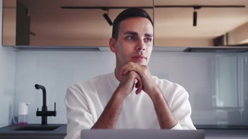Thoughtful Serious Young Man Student Writer Sit at Home Office Desk with Laptop Thinking of