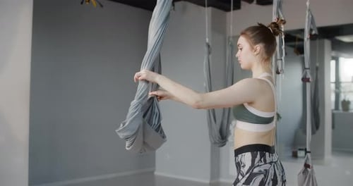 Attractive Young Woman Stretches Herself and Does Gymnastic Exercises in the Yoga Studio, Yoga