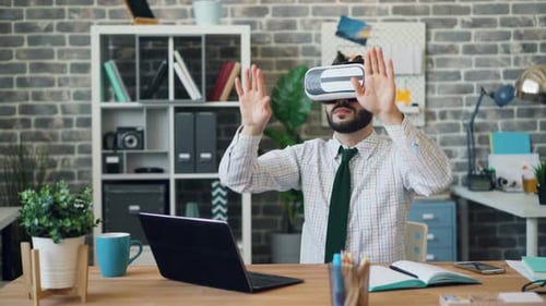 Man Using VR Headset at Office Desk