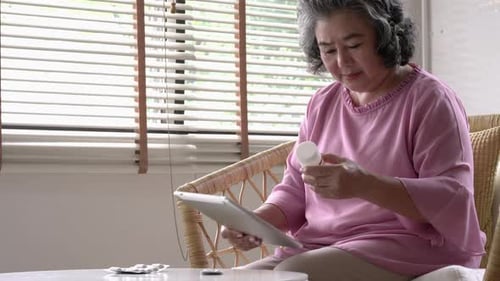 Senior woman searching medicine information with tablet