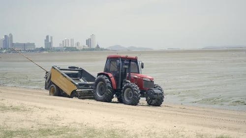 Tractor cleaning outdoor the sand on the beach