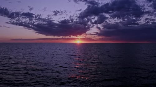 Drone Over Sea As Sun Sets On Horizon