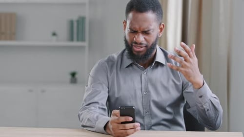 Adult Reacting Angrily to Content on Phone