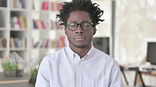 Young Adult Wearing Glasses Looking At Camera