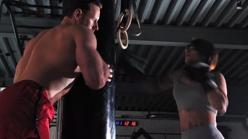 Woman Boxing with Coach at the Gym