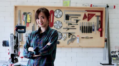 Portrait of Asian Carpenter wonman in wood workshop