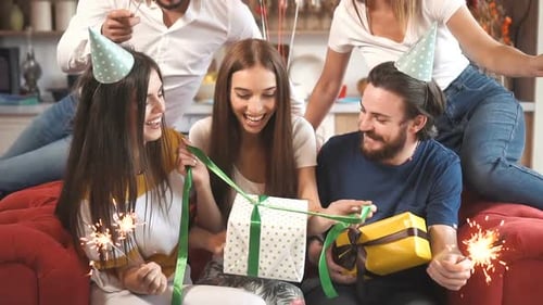 Friends Celebrating Birthday Party With Sparklers and Gifts