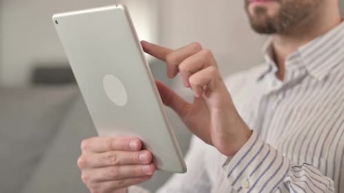 Close Up of Hands of Young Man Using Tablet