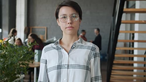 Slow Motion Portrait of Serious Woman Standing in Coworking Office Looking at Camera