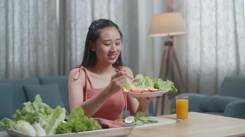 Woman Eats a Fresh Salad at Home