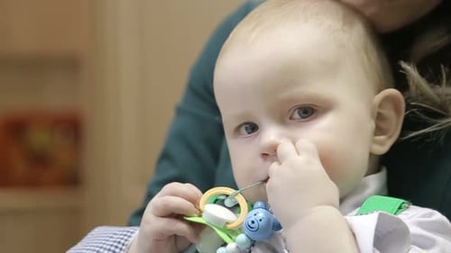 Close-Up of Blond Baby Holding a Pacifier