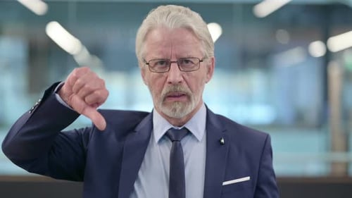 Portrait of Thumbs Down Gesture By Old Businessman