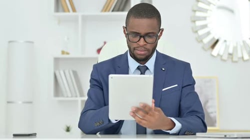 Man Working on Tablet in Modern Office