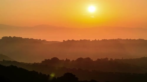 Landscape View of Rolling Hills During Sunrise